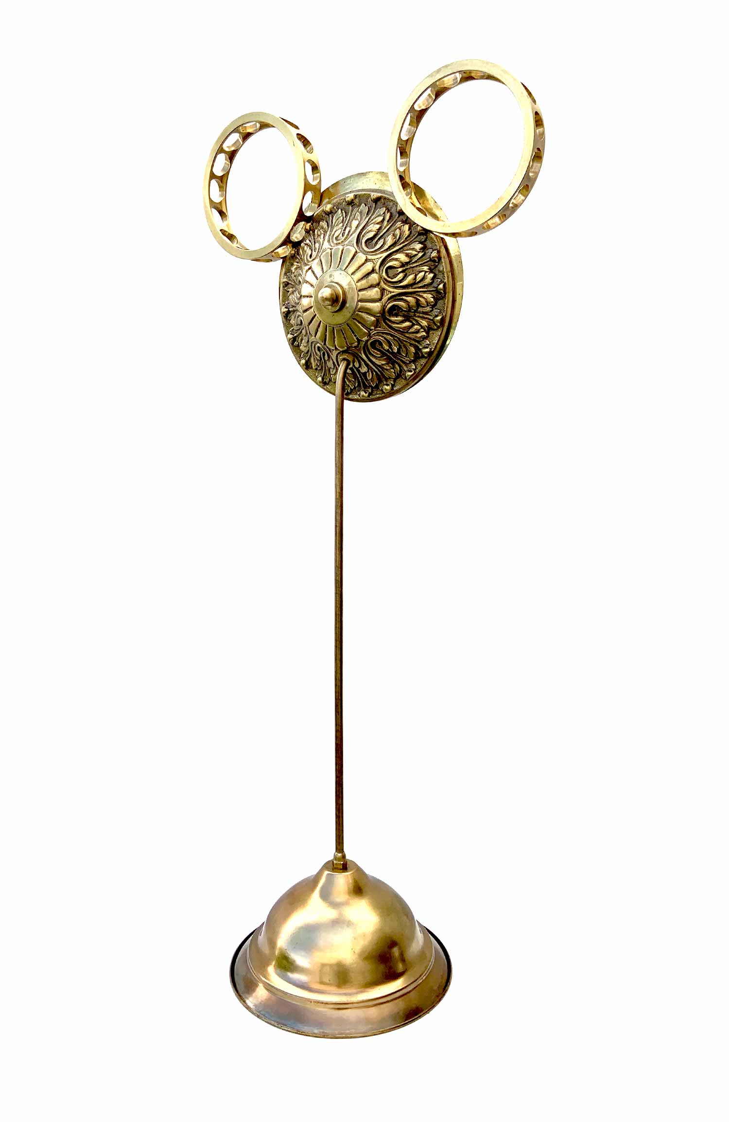 A sculpture with a face formed by a sphere with a knob for a nose and industrial brackets for ears, it has a base from which a stem supporting the head surfs.