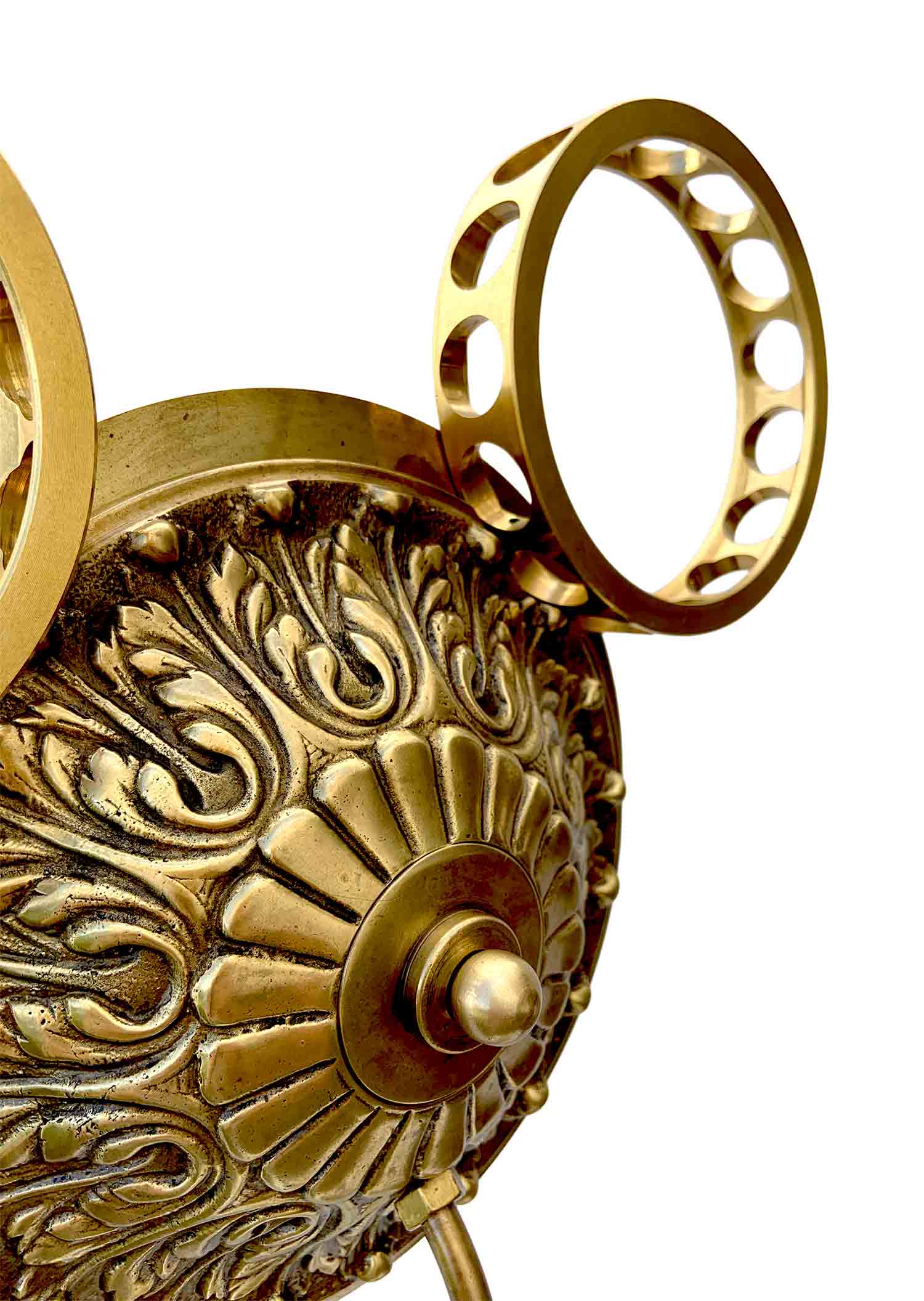 A sculpture with a face formed by a sphere with a knob for a nose and industrial brackets for ears, it has a base from which a stem surges that supports the head – detail.